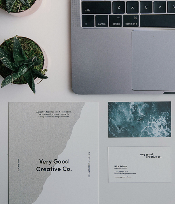 creative co. business card and postcard sitting on desktop
